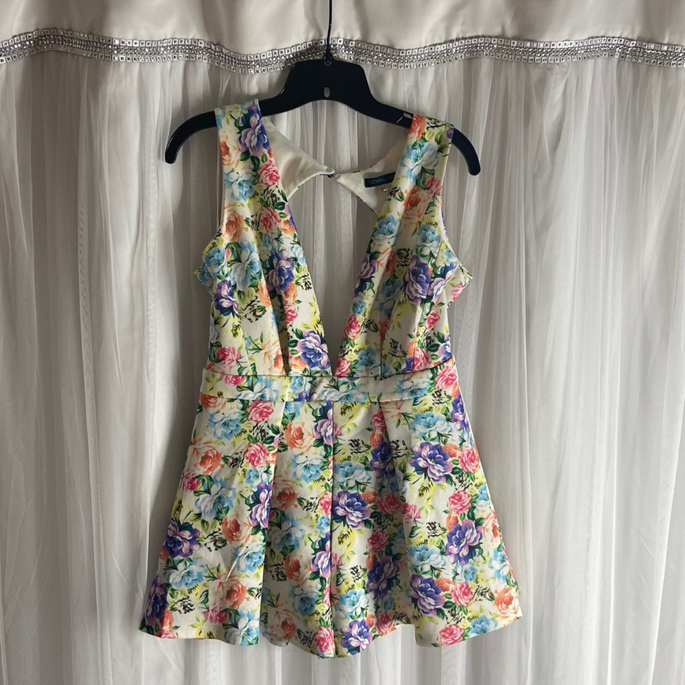 Beautiful summertime vibrant short romper with back out and low Vshape neck line
